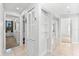 Hallway with built-in shelving and mirrored closet doors at 130 Green Dolphin Dr, Placida, FL 33946