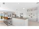Modern kitchen featuring white cabinetry, granite countertops, and bar seating at 130 Green Dolphin Dr, Placida, FL 33946