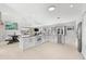 Kitchen with white cabinets, stainless steel appliances, and a view of the adjacent dining area at 130 Green Dolphin Dr, Placida, FL 33946