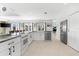 Modern kitchen featuring white cabinetry, stainless steel appliances, and an island with granite countertop at 130 Green Dolphin Dr, Placida, FL 33946