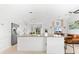 Modern kitchen featuring white cabinetry, a granite-topped island, and stainless steel appliances at 130 Green Dolphin Dr, Placida, FL 33946