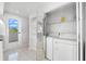 Laundry room with washer, dryer, and built-in shelving at 130 Green Dolphin Dr, Placida, FL 33946