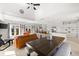 Living and dining area with high ceilings, a ceiling fan, and abundant natural light at 130 Green Dolphin Dr, Placida, FL 33946