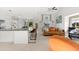 Open living area featuring an orange sofa, wooden coffee table, and barstool seating at the kitchen island at 130 Green Dolphin Dr, Placida, FL 33946