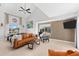 Spacious living room with high ceilings, a ceiling fan, and large windows at 130 Green Dolphin Dr, Placida, FL 33946