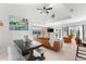 Living room with dining area, featuring a large wooden table and an orange leather couch at 130 Green Dolphin Dr, Placida, FL 33946