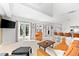 Inviting living room with an orange couch, coffee table, and large TV, open to the kitchen at 130 Green Dolphin Dr, Placida, FL 33946