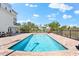 Private pool area with a curved design, surrounded by a paved patio and a metal fence at 130 Green Dolphin Dr, Placida, FL 33946