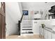 Stylish staircase with black and white steps and metal railing at 130 Green Dolphin Dr, Placida, FL 33946
