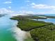 Aerial view of a serene waterfront area with lush vegetation and sparkling waters at 130 Green Dolphin Dr, Placida, FL 33946