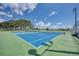 Two tennis courts with green surrounding at 1303 Cathedall Ave, North Port, FL 34288