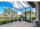 Covered patio area with serene water views and pavers at 13940 Miranese St, Venice, FL 34293