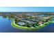 Scenic aerial view of community tennis courts by the lake at 13940 Miranese St, Venice, FL 34293