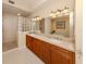 Spacious bathroom featuring double vanities, a glass-block shower, and a large soaking tub at 157 Tampa E Ave # 807, Venice, FL 34285