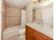 Modern bathroom with tiled shower/tub combo and wood vanity at 157 Tampa E Ave # 807, Venice, FL 34285
