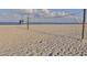 Volleyball net set up on a sandy beach with a lifeguard stand and ocean view at 157 Tampa E Ave # 807, Venice, FL 34285