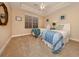 Comfortable bedroom with two twin beds, ceiling fan, and tranquil decor at 157 Tampa E Ave # 807, Venice, FL 34285