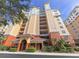 Condo building exterior with a grand entrance and lush landscaping at 157 Tampa E Ave # 807, Venice, FL 34285
