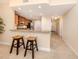 View of the kitchen with granite countertops, wood cabinets, and bar seating at 157 Tampa E Ave # 807, Venice, FL 34285