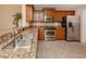 Kitchen with stainless steel appliances, granite countertops, and wood cabinetry at 157 Tampa E Ave # 807, Venice, FL 34285