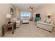 Living room with comfortable seating, coastal-inspired furniture and large windows at 157 Tampa E Ave # 807, Venice, FL 34285