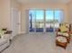 Living room with access to a balcony, offering panoramic views of the city at 157 Tampa E Ave # 807, Venice, FL 34285