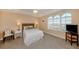 Relaxing main bedroom with arched windows, plush carpeting, and coastal-inspired decor at 157 Tampa E Ave # 807, Venice, FL 34285