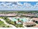 Luxurious resort-style pool and clubhouse amidst lush landscaping, palm trees, and blue skies at 17118 Vardon Ter # 202, Bradenton, FL 34211