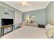 Relaxing bedroom with natural light, simple decor, and a comfortable chair at 17118 Vardon Ter # 202, Bradenton, FL 34211