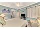 Relaxing bedroom with ceiling fan, TV, chair, and convenient access to bathroom at 17118 Vardon Ter # 202, Bradenton, FL 34211