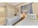 Cozy bedroom with twin beds, closet, and a window with blue blinds at 17118 Vardon Ter # 202, Bradenton, FL 34211