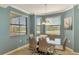 Bright dining area features a glass table and bay windows with scenic views at 17118 Vardon Ter # 202, Bradenton, FL 34211
