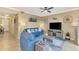 Comfortable living room features a blue sofa, ceiling fan, and coastal-themed decorations at 17118 Vardon Ter # 202, Bradenton, FL 34211