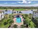 Community pool with a covered patio and lounge chairs at 17118 Vardon Ter # 202, Bradenton, FL 34211