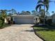 Single-story home with gray garage door and paver driveway at 1877 Lancashire Dr, Venice, FL 34293