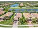 Aerial view of home with tile roof, solar panels, and landscaping at 19225 Jacinda St, Venice, FL 34293