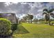 Landscaped backyard with lake view at 19279 Jacinda St, Venice, FL 34293