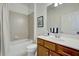 Clean bathroom with tub, shower, and wood vanity at 19279 Jacinda St, Venice, FL 34293
