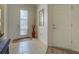Elegant entryway with tile flooring, white door, and decorative vase at 19279 Jacinda St, Venice, FL 34293
