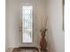 Front entry with white door and a decorative glass window at 19279 Jacinda St, Venice, FL 34293