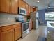Modern kitchen with stainless steel appliances and wood cabinets at 19279 Jacinda St, Venice, FL 34293