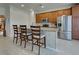 Kitchen island with seating and view into adjacent room at 19279 Jacinda St, Venice, FL 34293