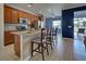 Modern kitchen with breakfast bar, granite countertops, and stainless steel appliances at 19279 Jacinda St, Venice, FL 34293