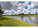 Serene lake view with lush landscaping at 19279 Jacinda St, Venice, FL 34293