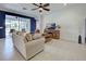 Bright living room with comfortable sofa and access to patio at 19279 Jacinda St, Venice, FL 34293
