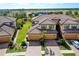 An aerial view of townhomes in a community, showcasing tile roofs and landscaping at 20100 Ragazza Cir # 101, Venice, FL 34293