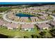An aerial view showcasing the community layout with a focus on the location of the property, including surrounding homes and amenities like a pond at 20100 Ragazza Cir # 101, Venice, FL 34293