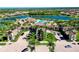 Aerial view of the community entrance, clubhouse, pool, and surrounding residences at 20100 Ragazza Cir # 101, Venice, FL 34293