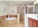 Spacious bathroom featuring a soaking tub, walk-in shower, and dual vanity at 20100 Ragazza Cir # 101, Venice, FL 34293