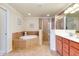 Large bathroom with a corner tub, separate shower, and double sink vanity at 20100 Ragazza Cir # 101, Venice, FL 34293